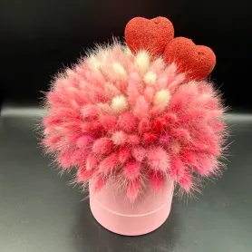 композиция из розового и кремового лагуруса с декоративными сердцами в розовой коробке
