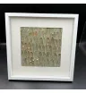 картина из серо-зелёных листьев и белых сухоцветов в белой рамке