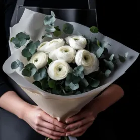 белые ранункулюсы с эвкалиптом в букете.