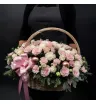 композиция из роз, эустомы, гвоздик, хвойной зелени и розовых декоративных шаров в корзине