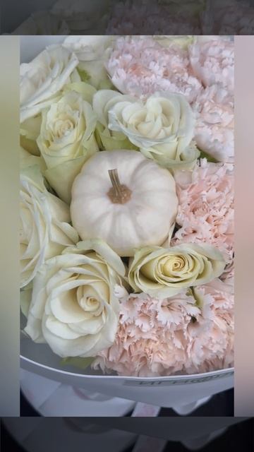 светлый букет из кремовых роз и персиковых гвоздик с белой декоративной тыквой